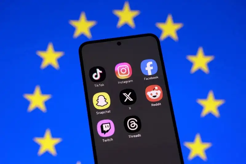FILE PHOTO: Illustration shows an EU flag and smartphone with displayed social media app icons